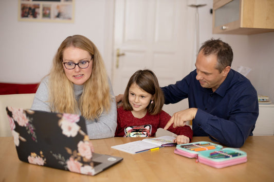 family at table looking at computer